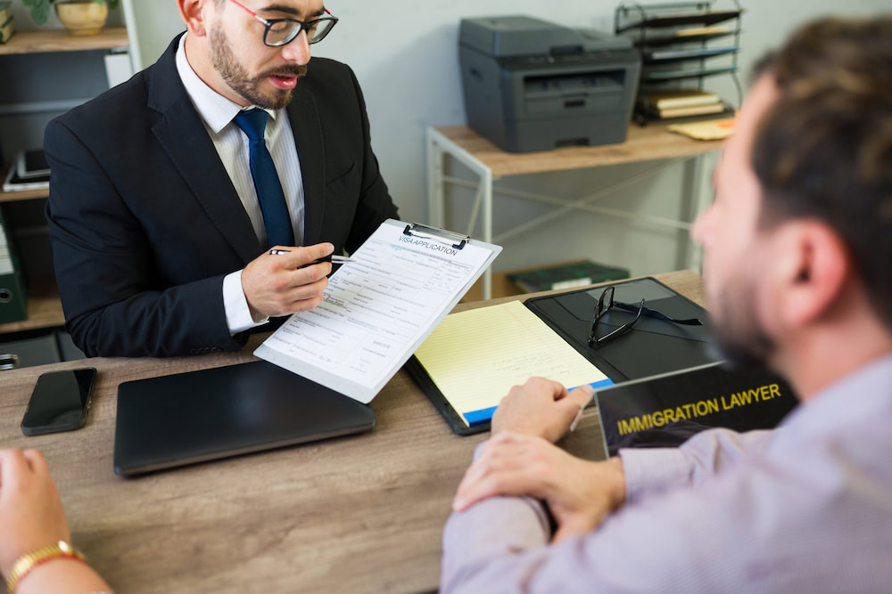 Thai immigration lawyer guiding his client on his US visa application for Thai wife.
