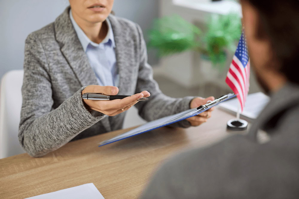 Officer reviewing proof of relationship documents during a K-1 visa interview
