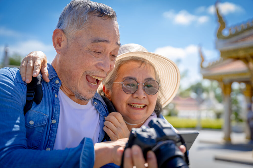 Elderly couple exploring Bangkok after comparing marriage visa vs. retirement visa in Thailand.