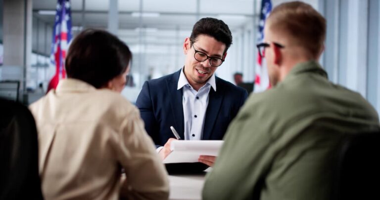 A couple organizing K-1 visa paperwork with an immigration lawyer. Clean records help avoid a denial.