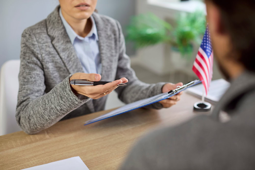 A consular officer reviewing a K-1 fiancé visa petition. The interview stage is where many denials occur.
